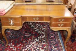 A Louis XV style walnut five drawer writing table, on slender cabriole legs W.130cm