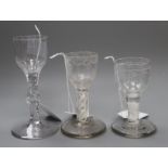 An 18th century cordial glass with bucket bowl and facet stem and two firing glasses, each with