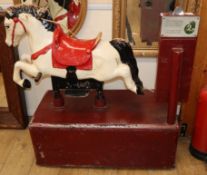 An electric coin operated painted wooden rocking horse L.102cm