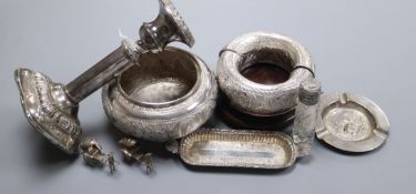 A Malayan white metal bowl, flower holders, two dishes and a silver candlestick.