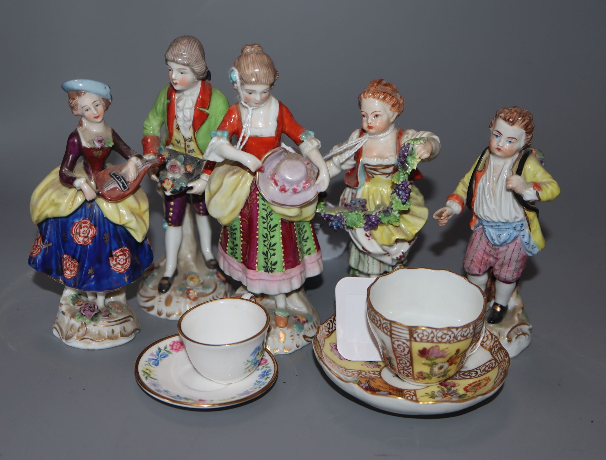 A pair of Samson figures of a couple, three small Thuringien figures and two miniature cups and