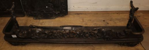 A Victorian cast iron kerb, with scrolled acanthus front, together with attached fire dogs, and