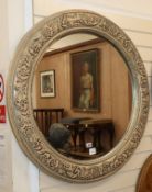 A circular wall mirror, with carved foliate border Diameter 96cm