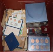 A collection of UK & World coinage, medals and stamps, to include cased years sets, a silver crown