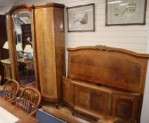 An early 20th century French tulip-banded walnut three piece bedroom suite comprising mirrored '