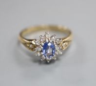 A modern 9ct gold, sapphire and diamond cluster ring, size O.