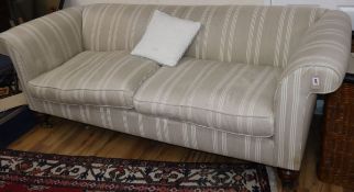 A Victorian style Chesterfield settee, upholstered in cream striped material L.220cm