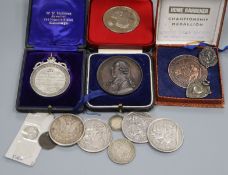 A small group of coins, including crowns and four cased medallions.