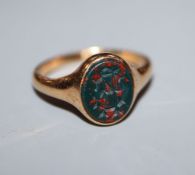 An 18ct gold and oval monogrammed bloodstone set signet ring, size O.