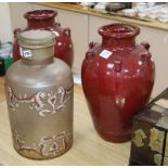 A Victorian black painted opaque glass jar and cover, together with a pair of red glazed