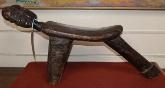 A carved tribal double headed stool