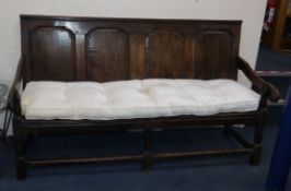 A mid 18th century panelled oak settle L.186cm