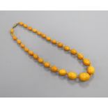 A single strand graduated oval amber bead necklaces, gross weight 26 grams, 44cm.