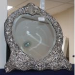 A late Victorian silver-mounted easel toilet mirror with heart-shaped plate, all over pierced with