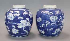 A pair of 19th century Chinese blue and white 'prunus' jars, Kangxi marks height 19cm