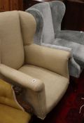 Two upholstered wing armchairs