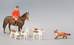 A Beswick fox hunting set including horse and huntsman, five hounds and a fox