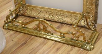 A Victorian brass fender