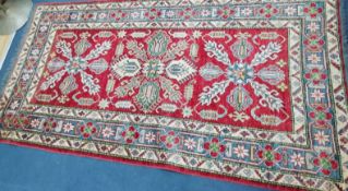 An Afghan rug 230 x 118cm