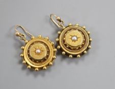 A pair of Victorian yellow metal and split pearl set target earrings, with beaded borders,