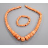 A coral bead necklace and a similar bracelet.