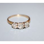 An 18ct and three stone diamond ring, size O/P.