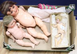 A smart bisque-headed doll, two others and a collection of doll's clothes