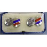 A cased pair of sterling and three colour enamel military related oval cufflinks.