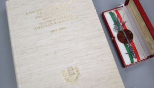 An Iron Curtain barbed wire piece, boxed with certificate, together with a book on the Hungarian