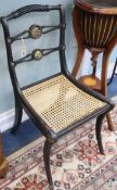 Two similar Regency ebonised canework chairs