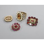 A 19th century yellow metal and seed pearl mourning brooch, two Victorian garnet brooches and an