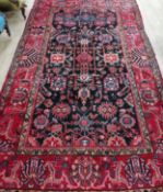 A Hamadan red ground carpet 330 x 200cm