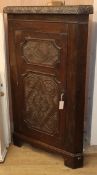 A Victorian carved oak standing corner cupboard W.88cm