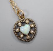 An Edwardian heart shaped white opal and seed pearl set heart shaped pendant on a fine link chain,