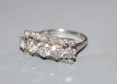 A five stone diamond and white metal (tests as platinum) line-set dress ring, with diamond set