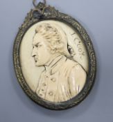 A 19th century carved ivory oval portrait plaque, signed J. Cook