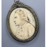 A 19th century carved ivory oval portrait plaque, signed J. Cook