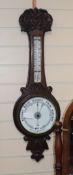 An Edwardian oak wheel barometer and thermometer H.82cm