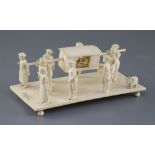 A 19th century Indian carved ivory group of a nobleman being carried in a sedan chair, attended by