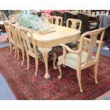 A Queen Anne style figured walnut dining table and eight dining chairs (two with arms) table L.