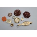Two garnet brooches, two intaglio cut stones, a Victorian garnet and seed pearl set mourning brooch,