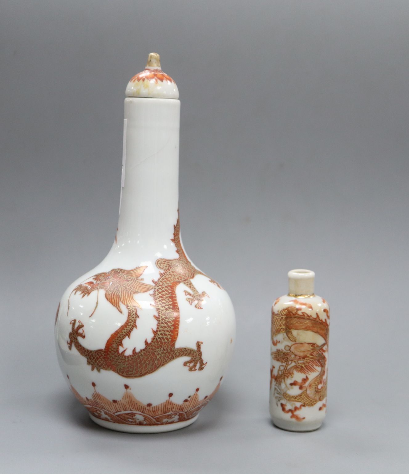 A Chinese rouge de fer and gilt 'dragon' snuff bottle vase and cover and a snuff bottle, late 19th