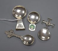 Four assorted Arts & Crafts style silver caddy spoons including enamelled, two Scottish including