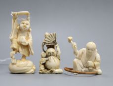 Three Japanese ivory netsuke of Daruma and two men, Hotei and a craftsman, Meiji-Taisho period