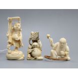 Three Japanese ivory netsuke of Daruma and two men, Hotei and a craftsman, Meiji-Taisho period