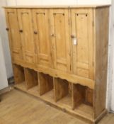 An early 20th century bank of pine golf lockers W.160cm