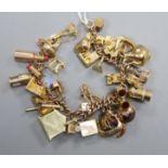 A 9ct charm bracelet hung with assorted charms, including bicycle, cathedral, cannon and minor's