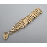 A 9ct gold gatelink bracelet with heart shaped padlock clasp.