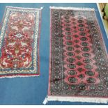 A Bokhara pink ground rug and a small Persian rug, woven with birds and animals (2) Larger 160cm x