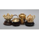 Four Satsuma miniature vessels and three hardwood stands tallest 9cm